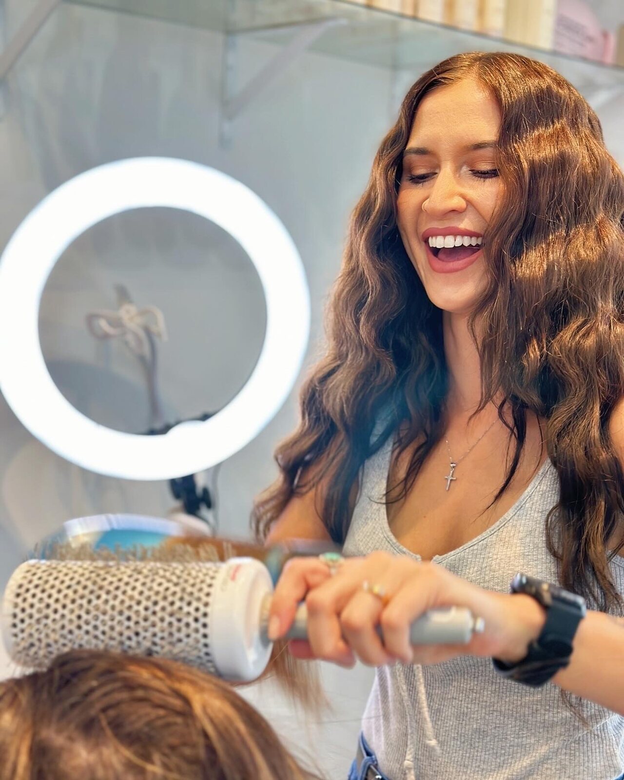 Ashley styling a client at Ash Allure Beauty in Austin